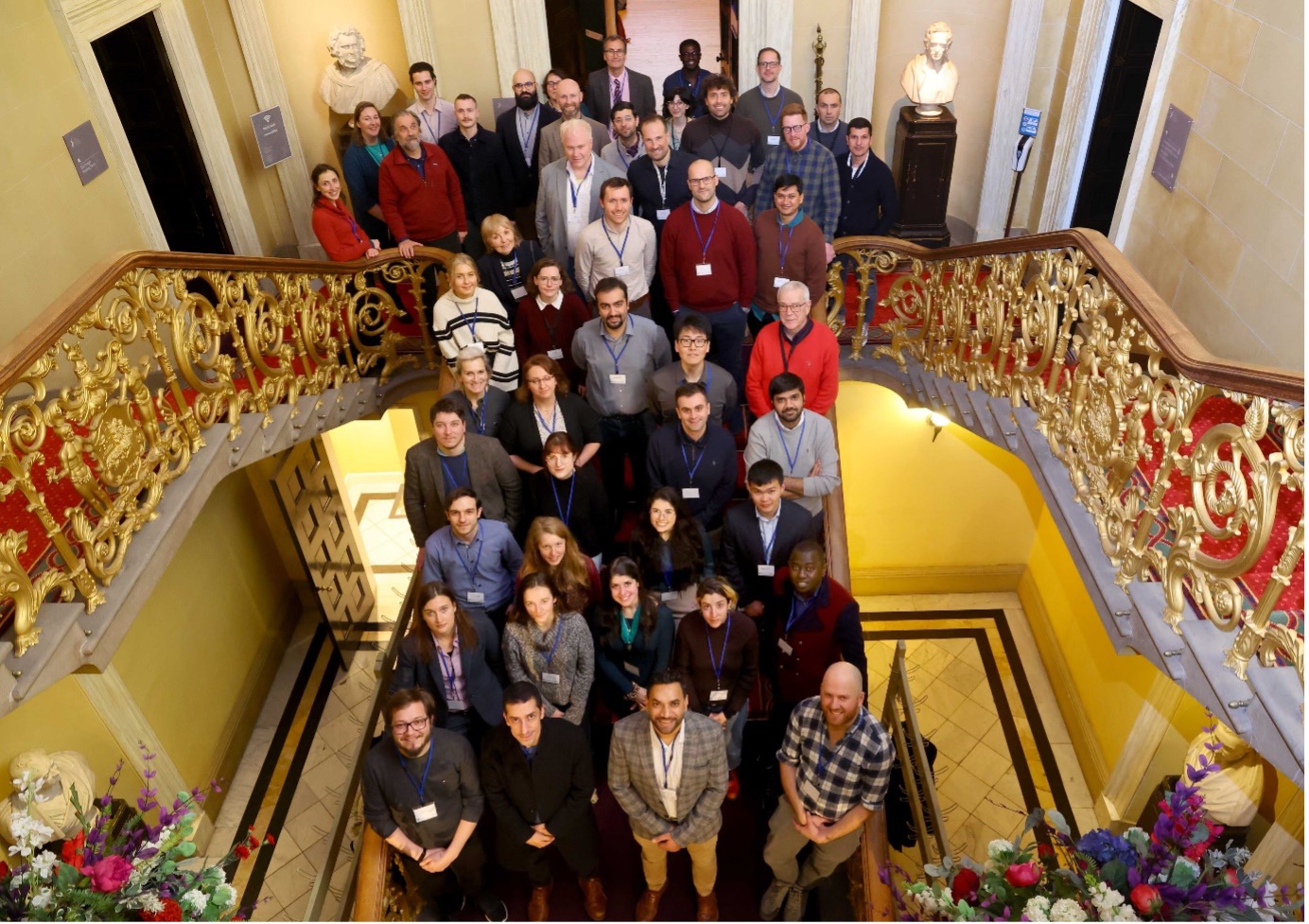 Group shot of attendees on the stairwell logo