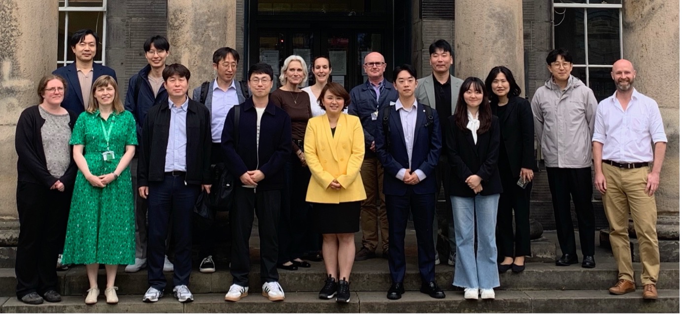 group shot of Korean delegation and SCCS logo