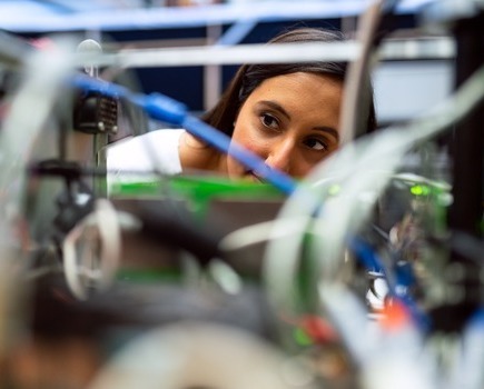 A scientist investigating some piping